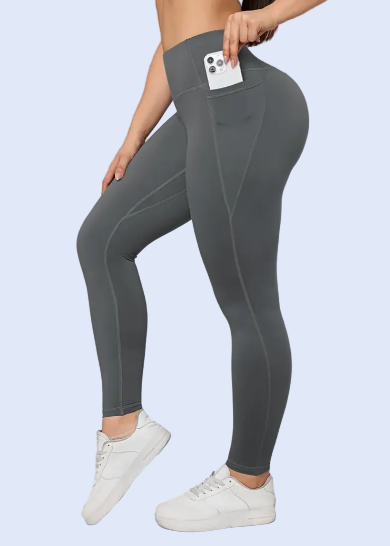 Person wearing gray leggings with a white background