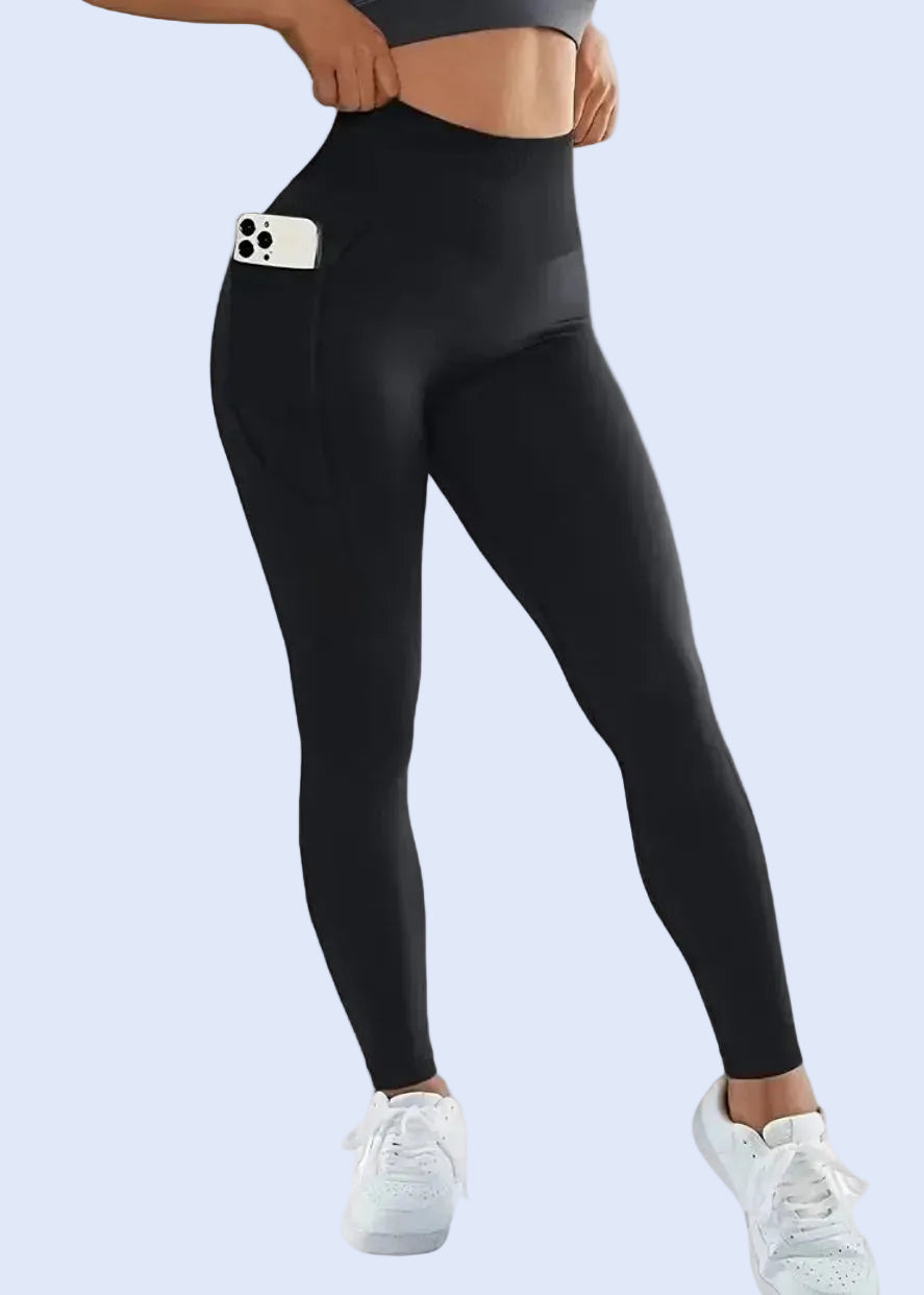 Woman wearing black high-waisted gym leggings with phone pocket from GymDeity activewear