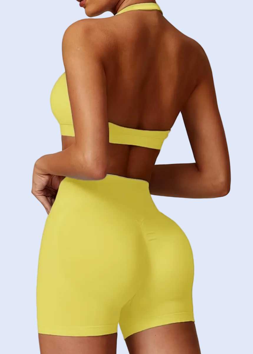 Person wearing a yellow bikini set on a plain background