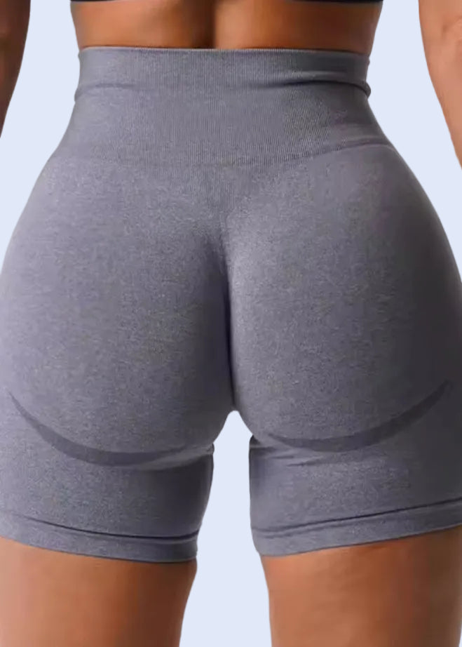 Gray athletic shorts worn by a person on a white background