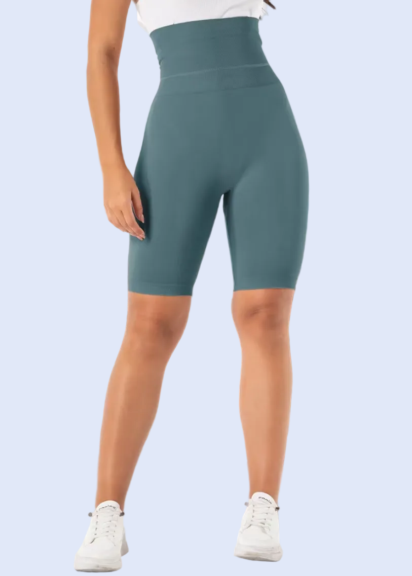 Person wearing teal high-waisted shorts in a living room setting