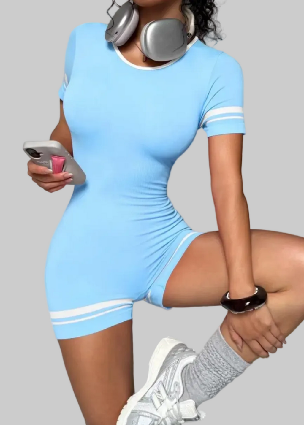 Woman in a blue dress with white stripes on a gray background