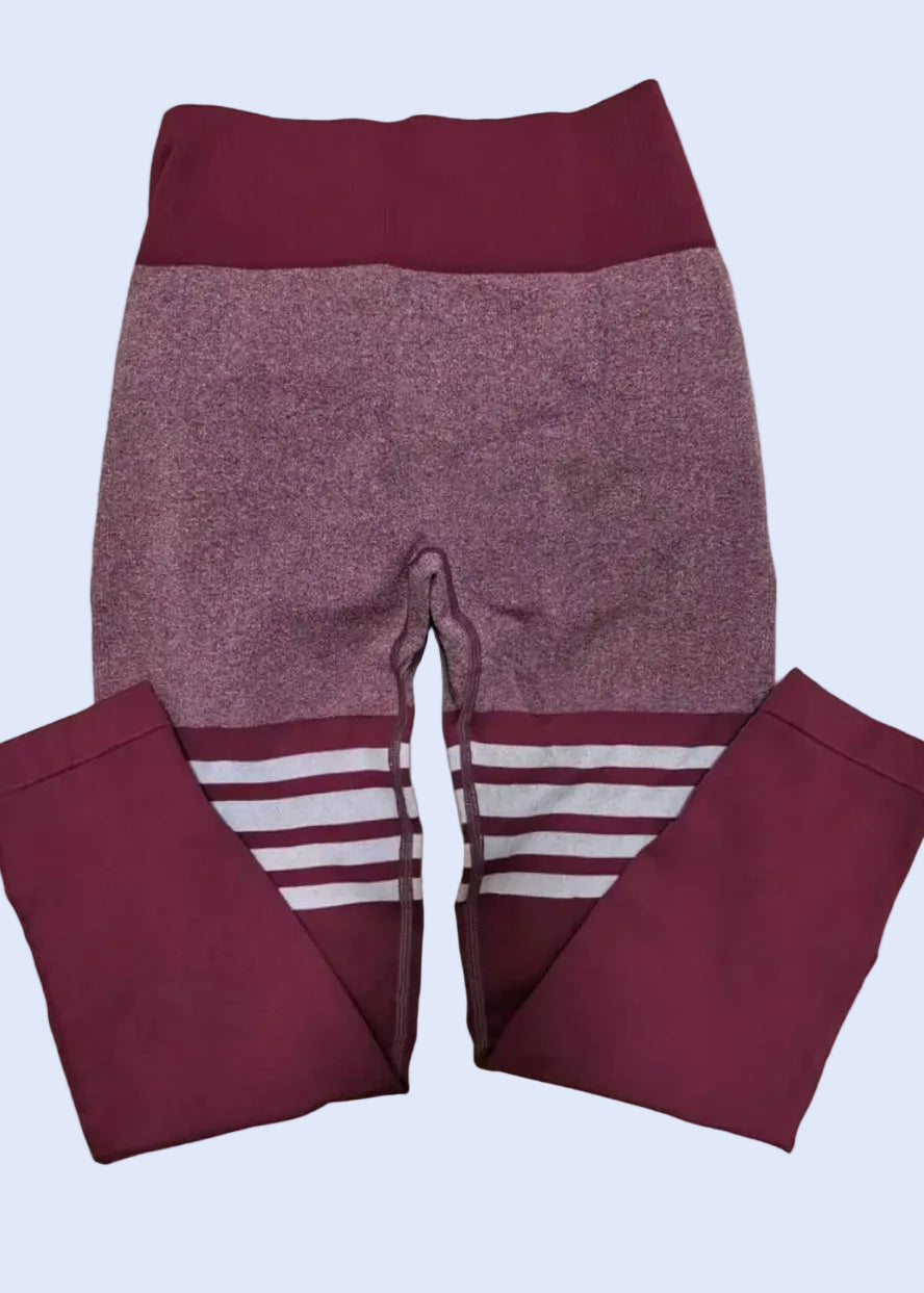 Maroon leggings with a white stripe on a beige background
