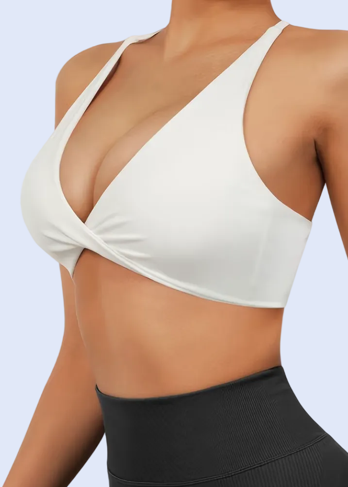 White sports bra and black leggings on a person against a white background