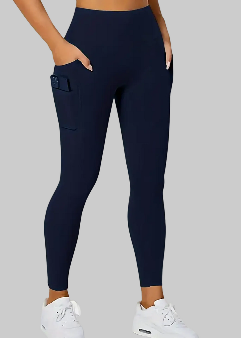 Navy leggings worn by a person on a beige background