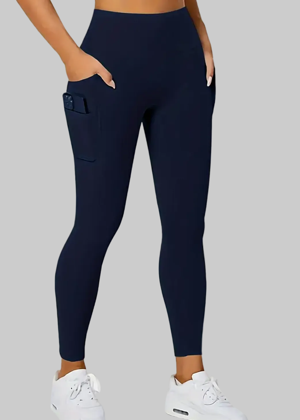 Navy leggings worn by a person on a beige background