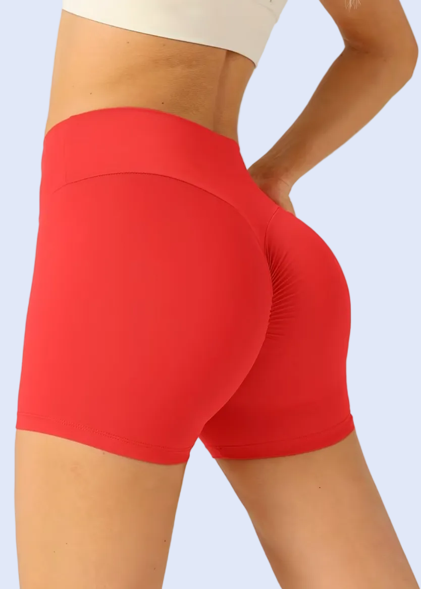 Red athletic shorts worn by a person on a white background