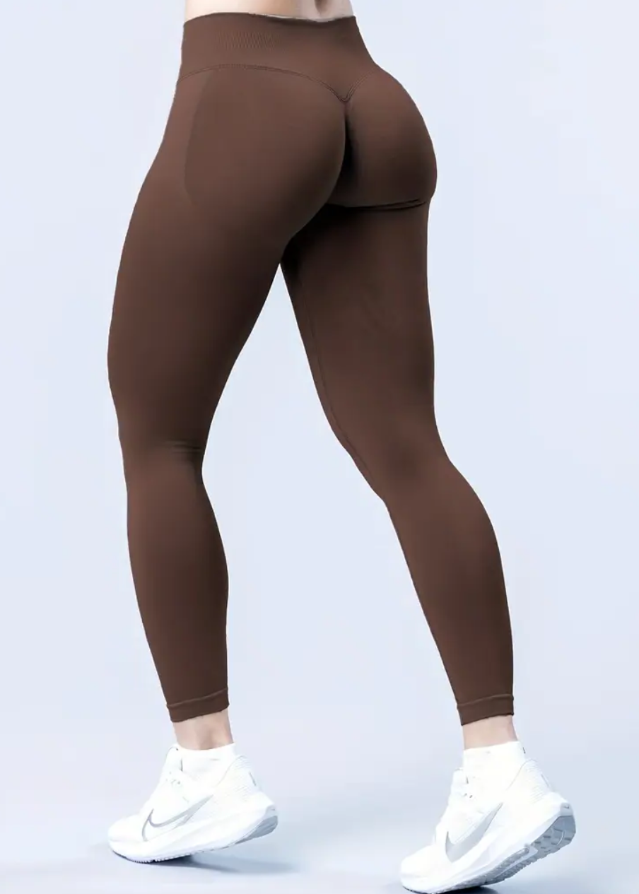 Brown leggings worn by a person on a light gray background