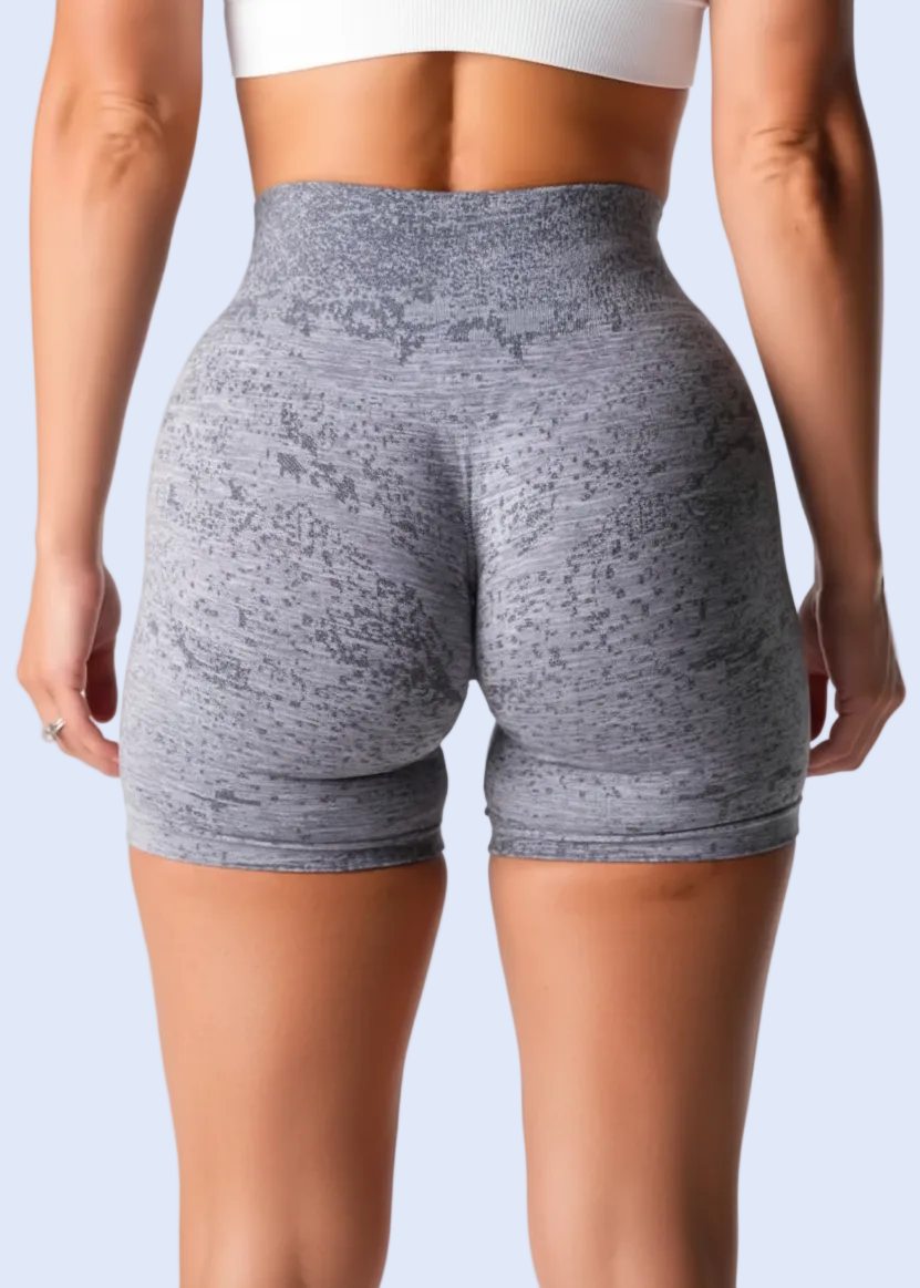 Light gray athletic shorts worn by a person on a white background