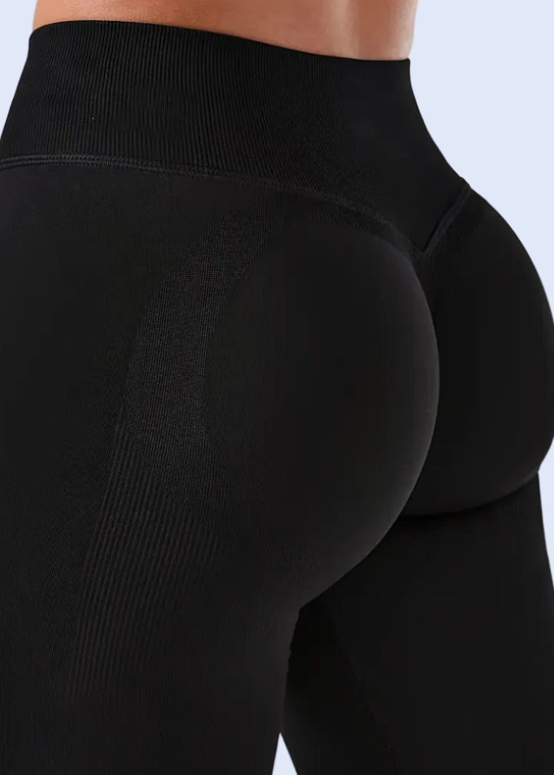 Black leggings being worn on a white background