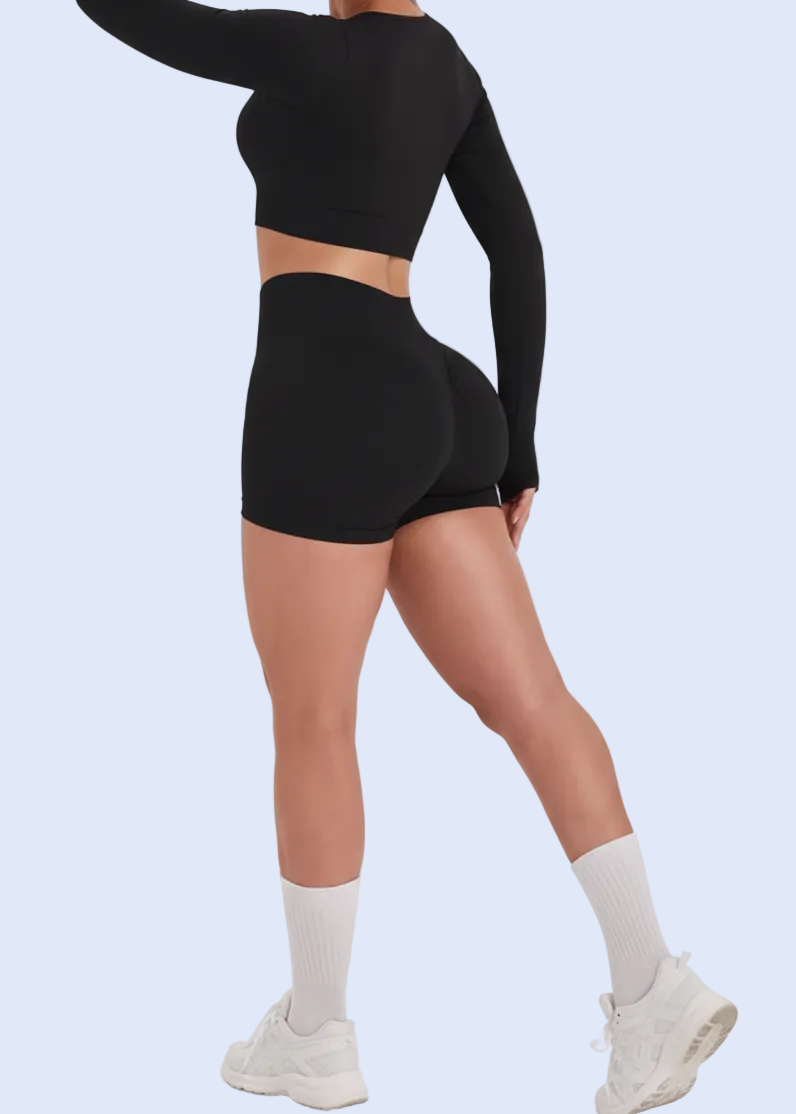 Woman wearing a black athletic outfit with text on a white background