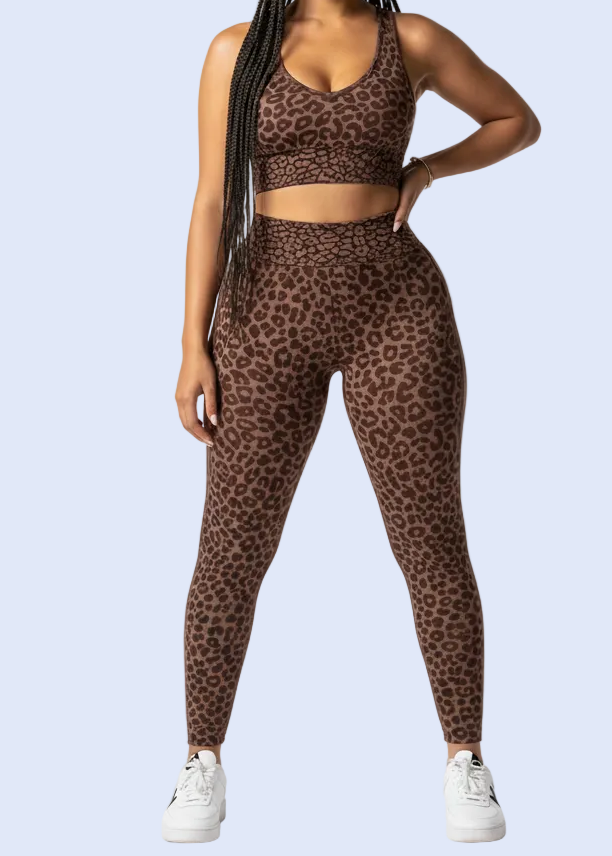 Woman in brown patterned workout outfit on a gray background with shopping cart icon at the bottom.