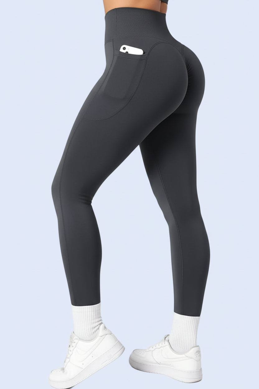 Black leggings worn by a person on a light gray background