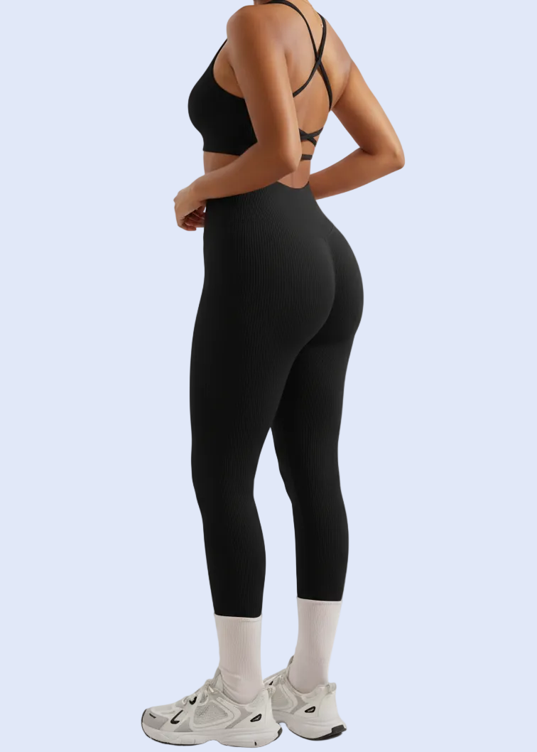 Two women wearing black athletic outfits on a white background