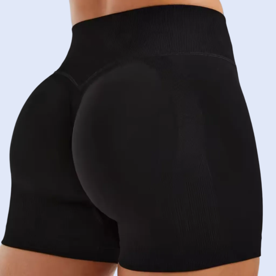 Black athletic shorts worn by a person on a white background