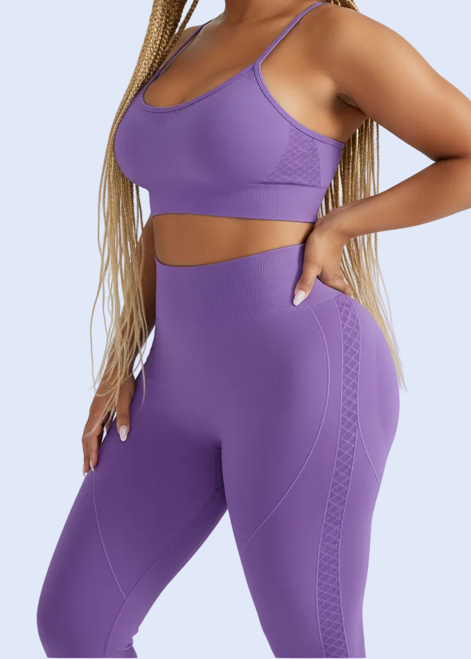 Person wearing a purple sports bra and leggings on a light gray background