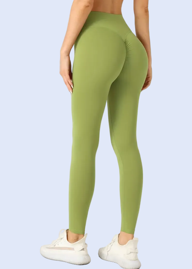 Person wearing green leggings on a white background
