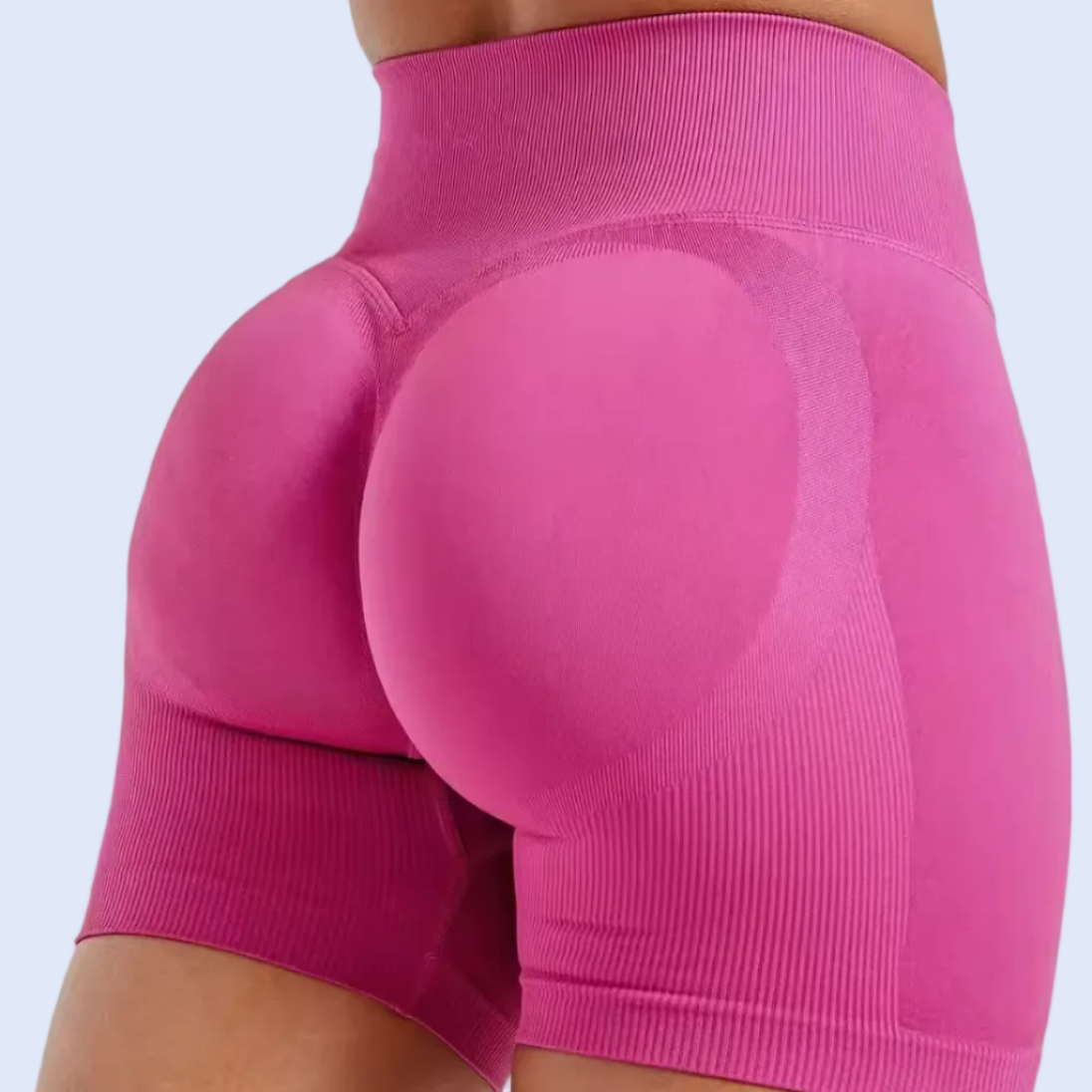 Pink athletic shorts on a white background