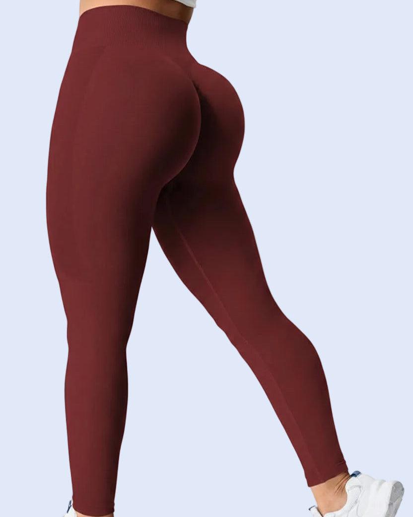 Maroon leggings worn by a person on a white background