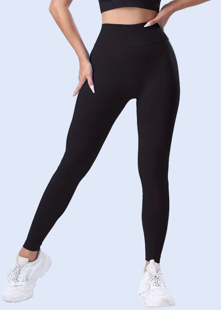 Person wearing black leggings on a white background