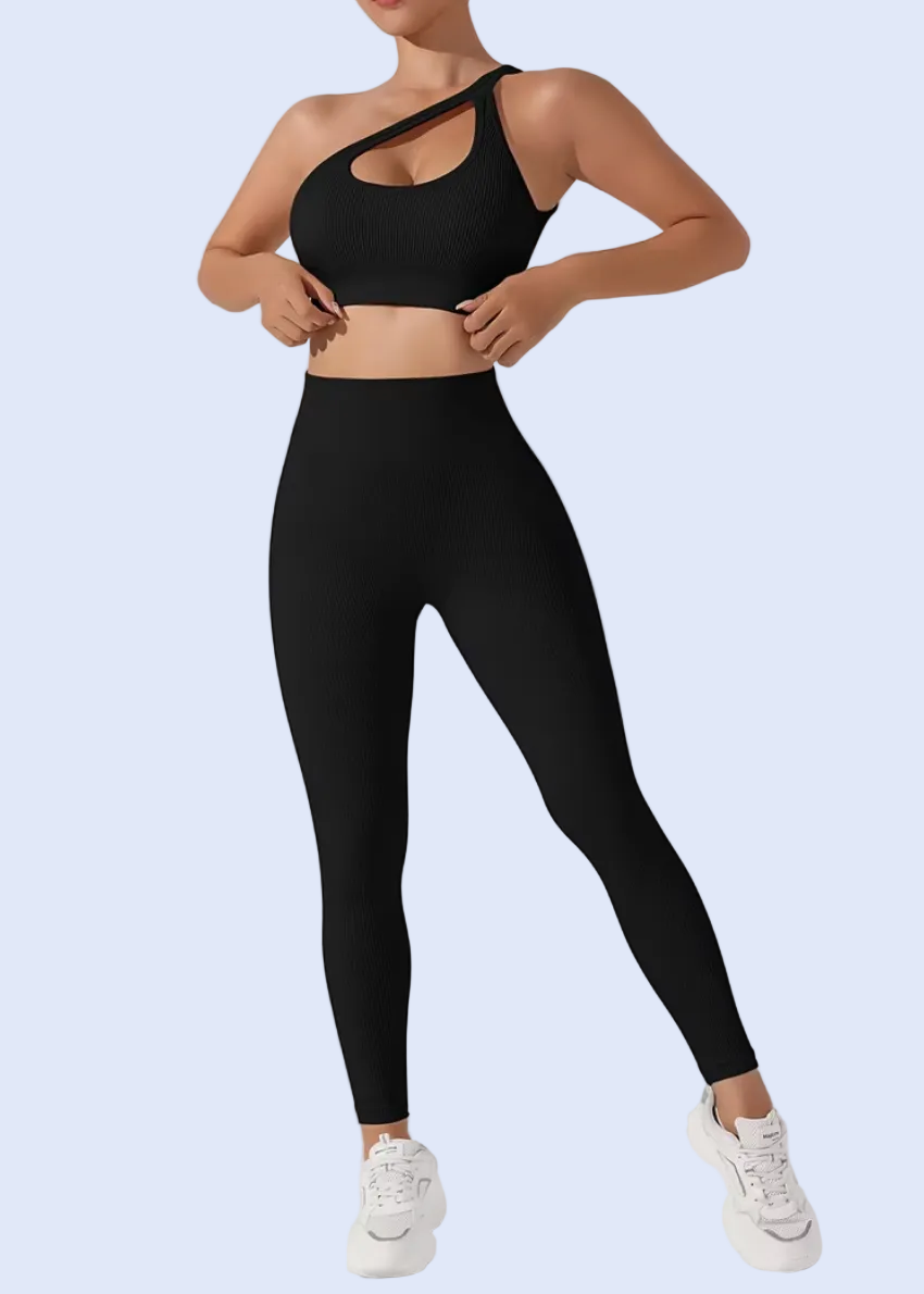 Person wearing a black sports bra and leggings on a light gray background
