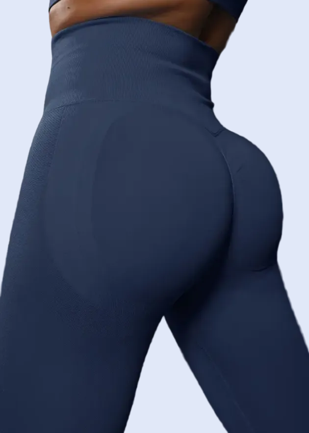 Person wearing blue leggings on a dark background