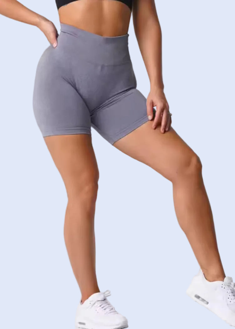 Person wearing gray athletic shorts on a white background