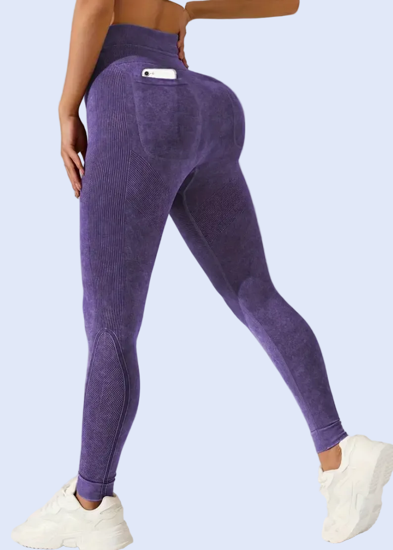 Person wearing purple leggings on a light gray background