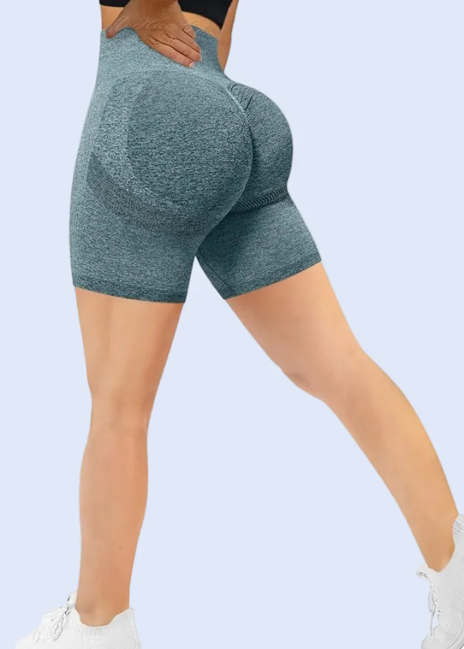 Person wearing blue leggings on a white background with Amazon.com displayed in the browser tab.