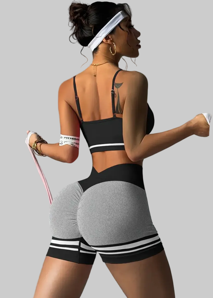 Woman exercising with resistance bands on a gray background