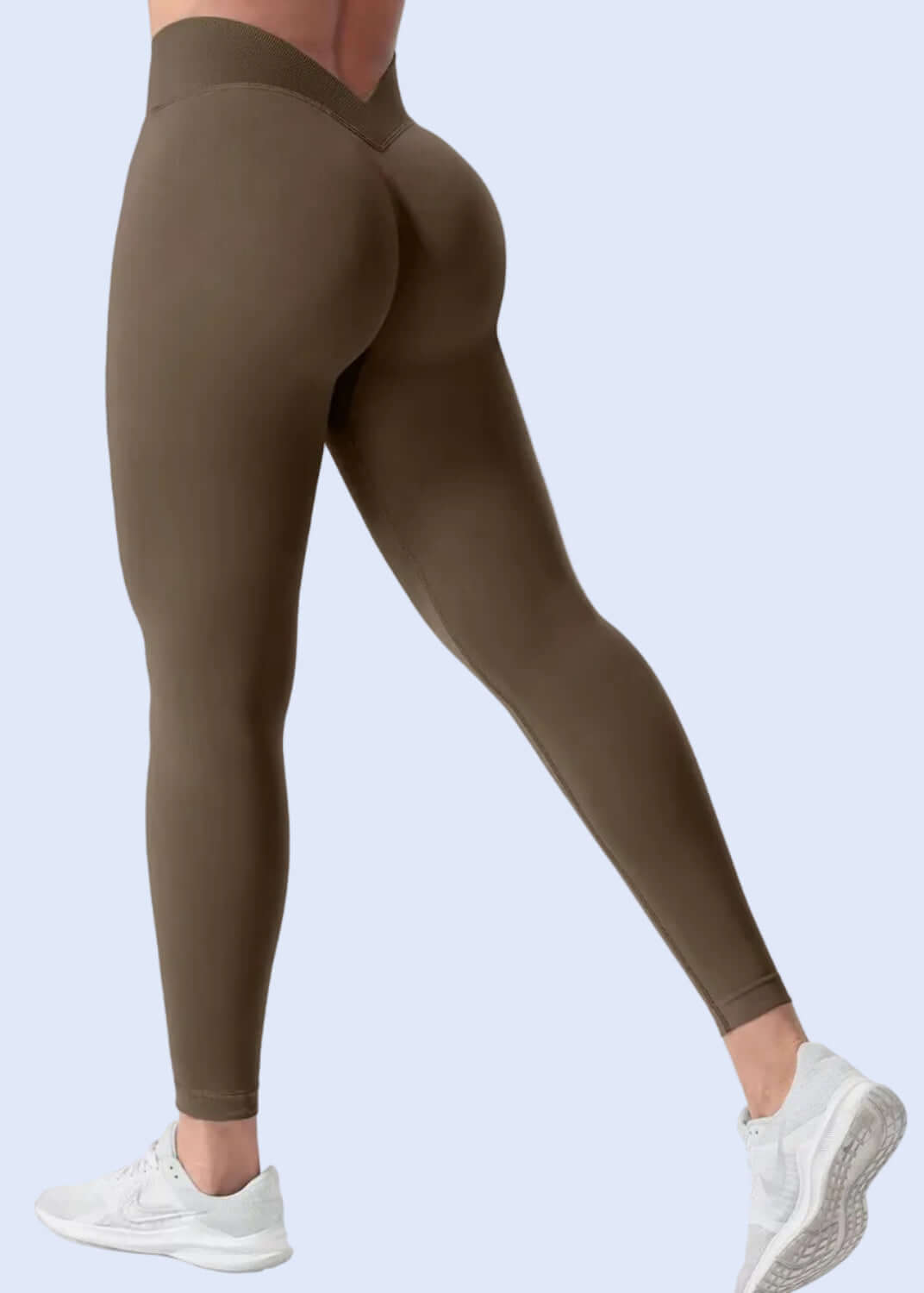 Brown leggings worn by a person on a white background