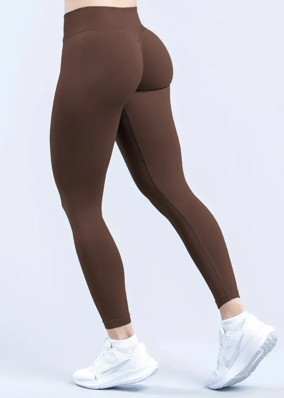 Brown leggings worn by a person on a white background