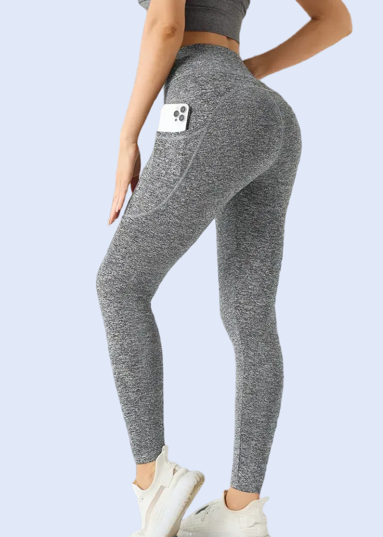 Person wearing gray leggings in a room with a mirror and shoes.