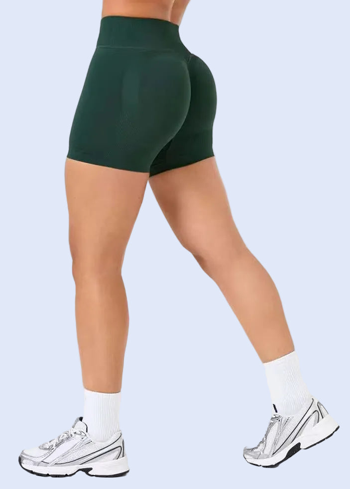 Green athletic shorts worn by a person on a white background