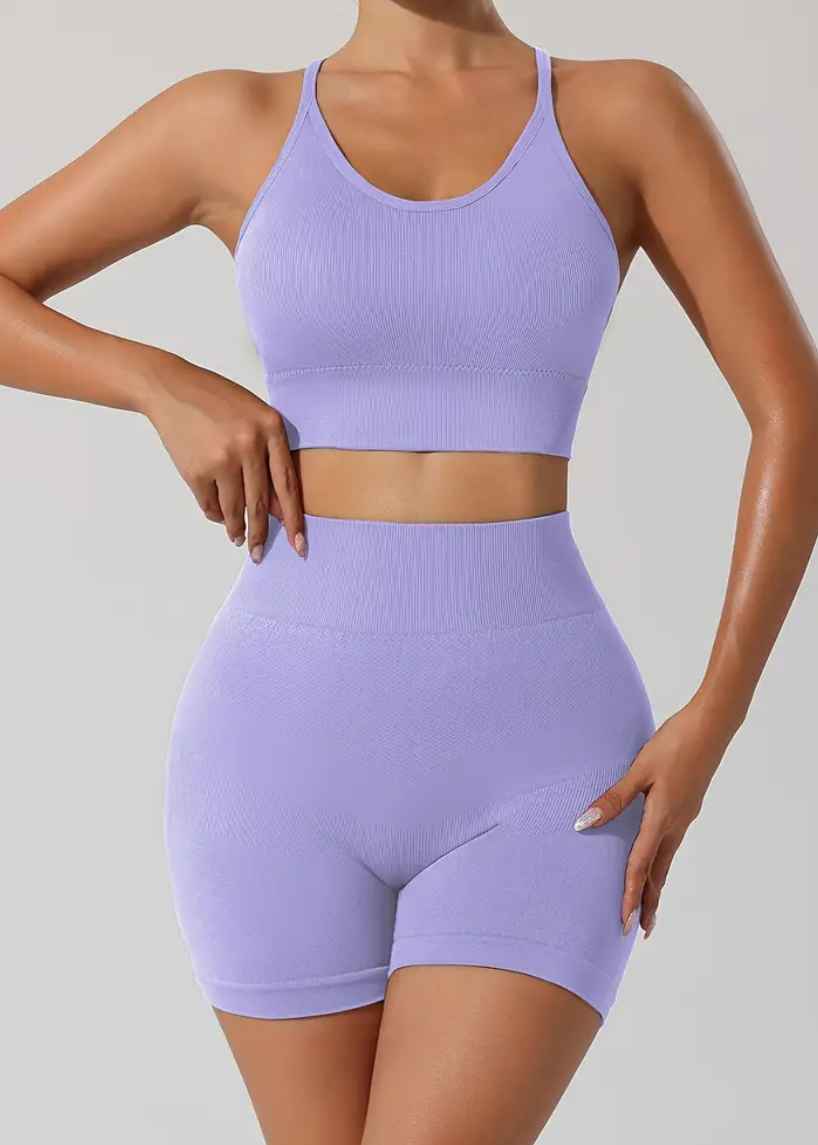 Person wearing a purple athletic outfit on a plain background