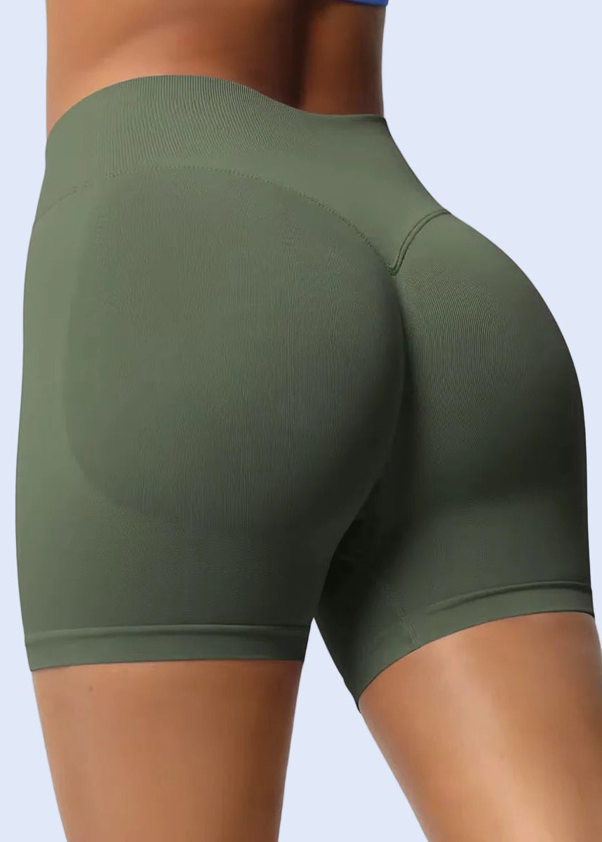 Green athletic shorts worn by a person on a plain background