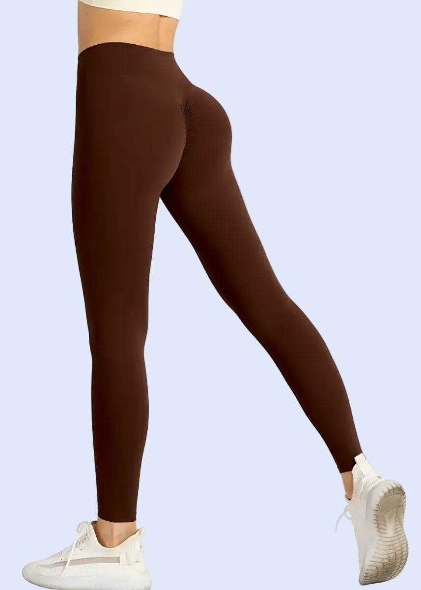 Brown leggings worn by a person on a white background