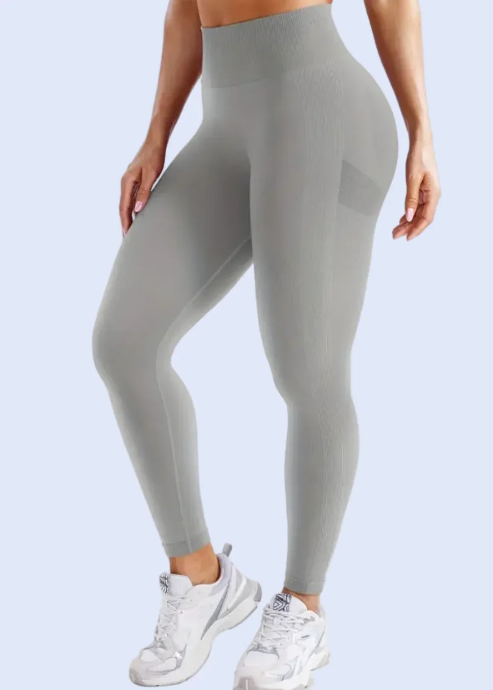 Gray leggings worn by a person on a white background
