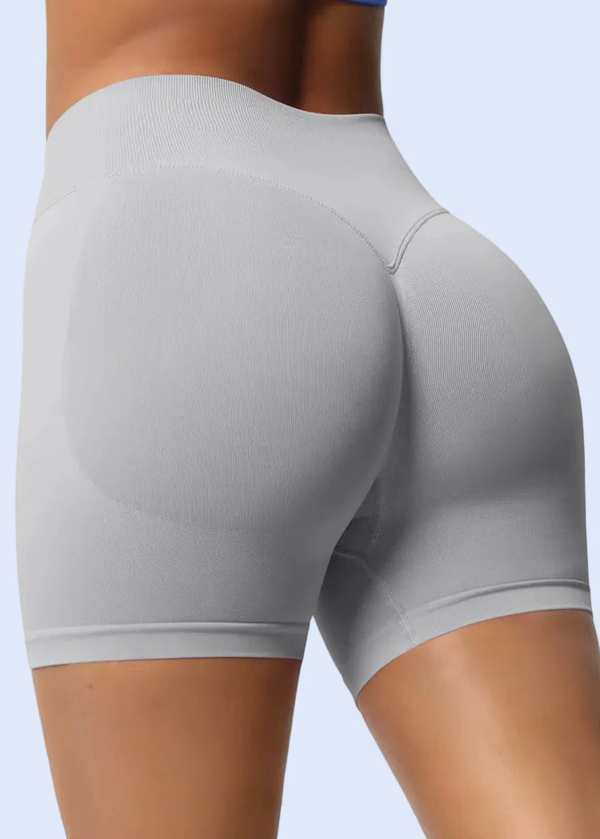 Gray athletic shorts worn by a person on a plain background