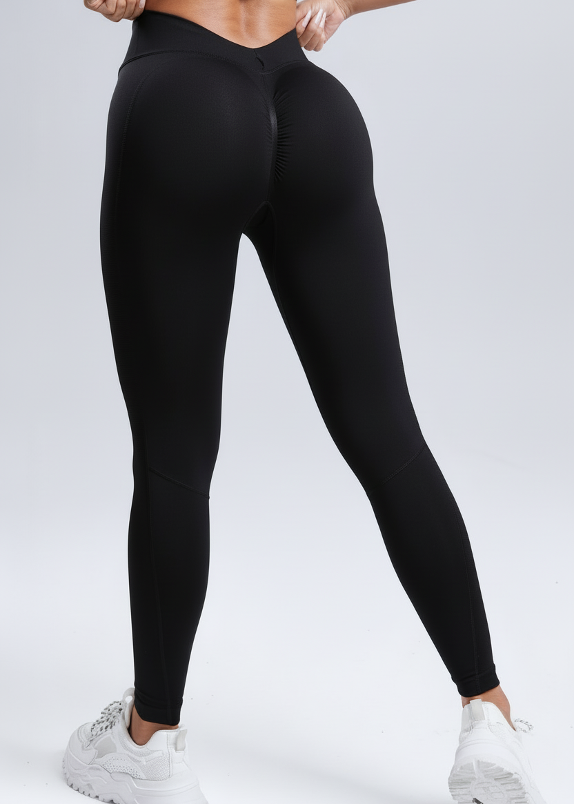 Person wearing black leggings on a light gray background