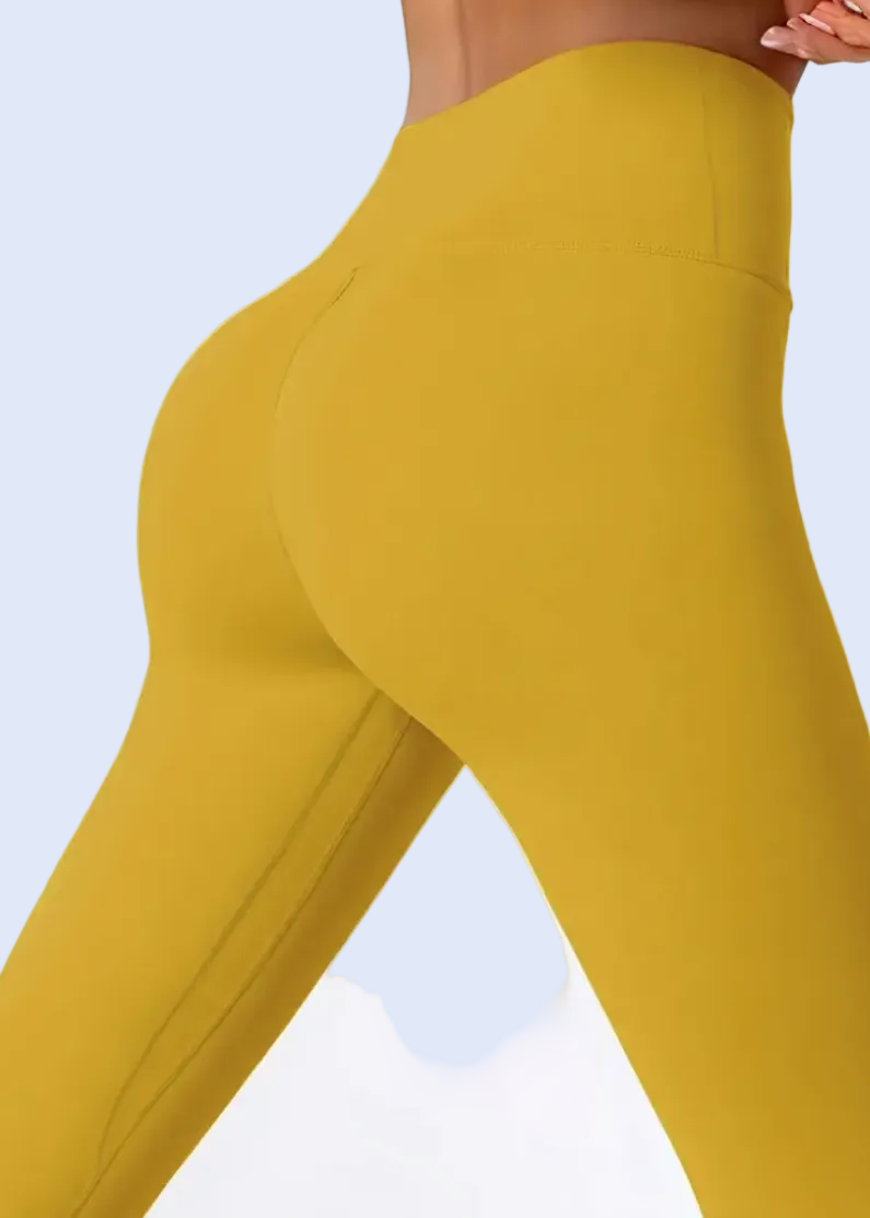 Mustard yellow leggings on a white background