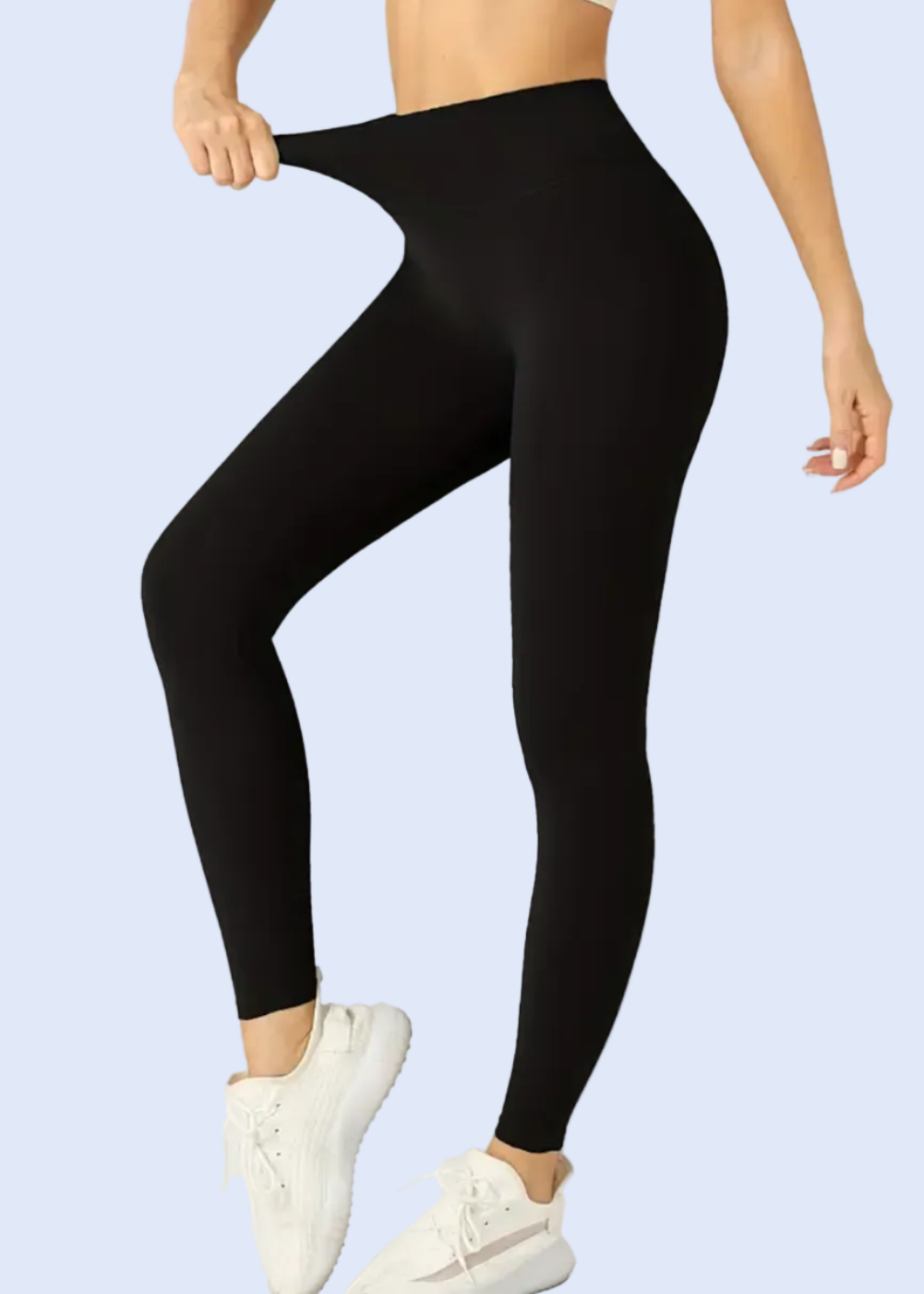Person wearing black leggings on a white background