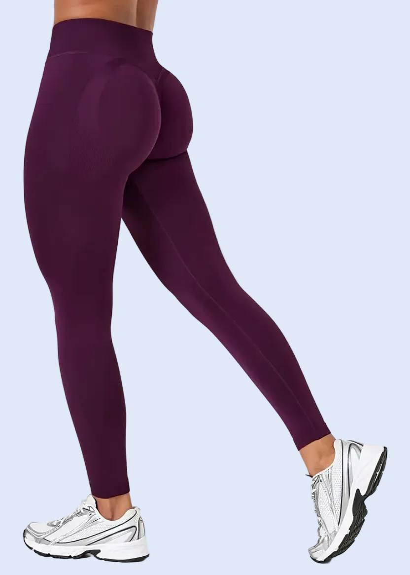 Purple leggings worn by a person on a white background