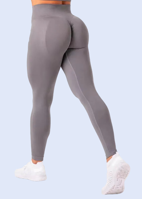 Gray leggings worn by a person on a white background