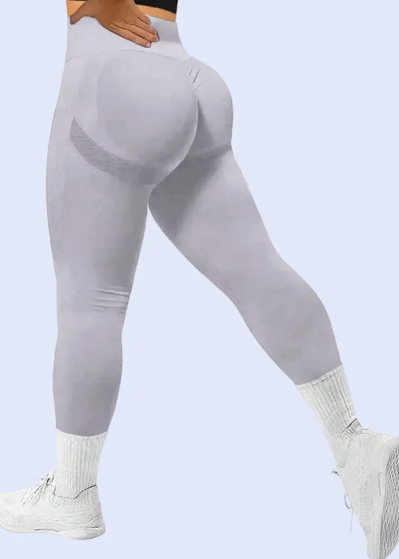 Light gray leggings worn by a person on a white background