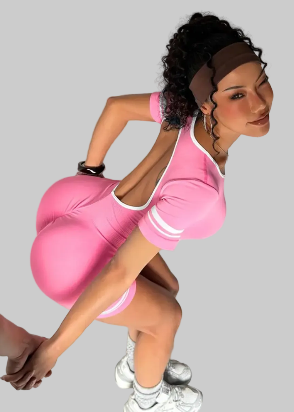 Person wearing a pink outfit with a white background