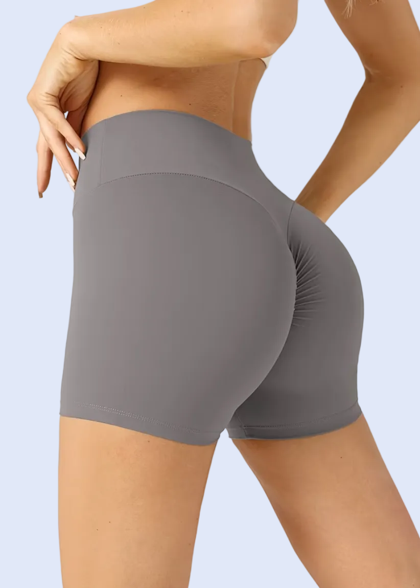 Gray athletic shorts worn by a person on a plain background