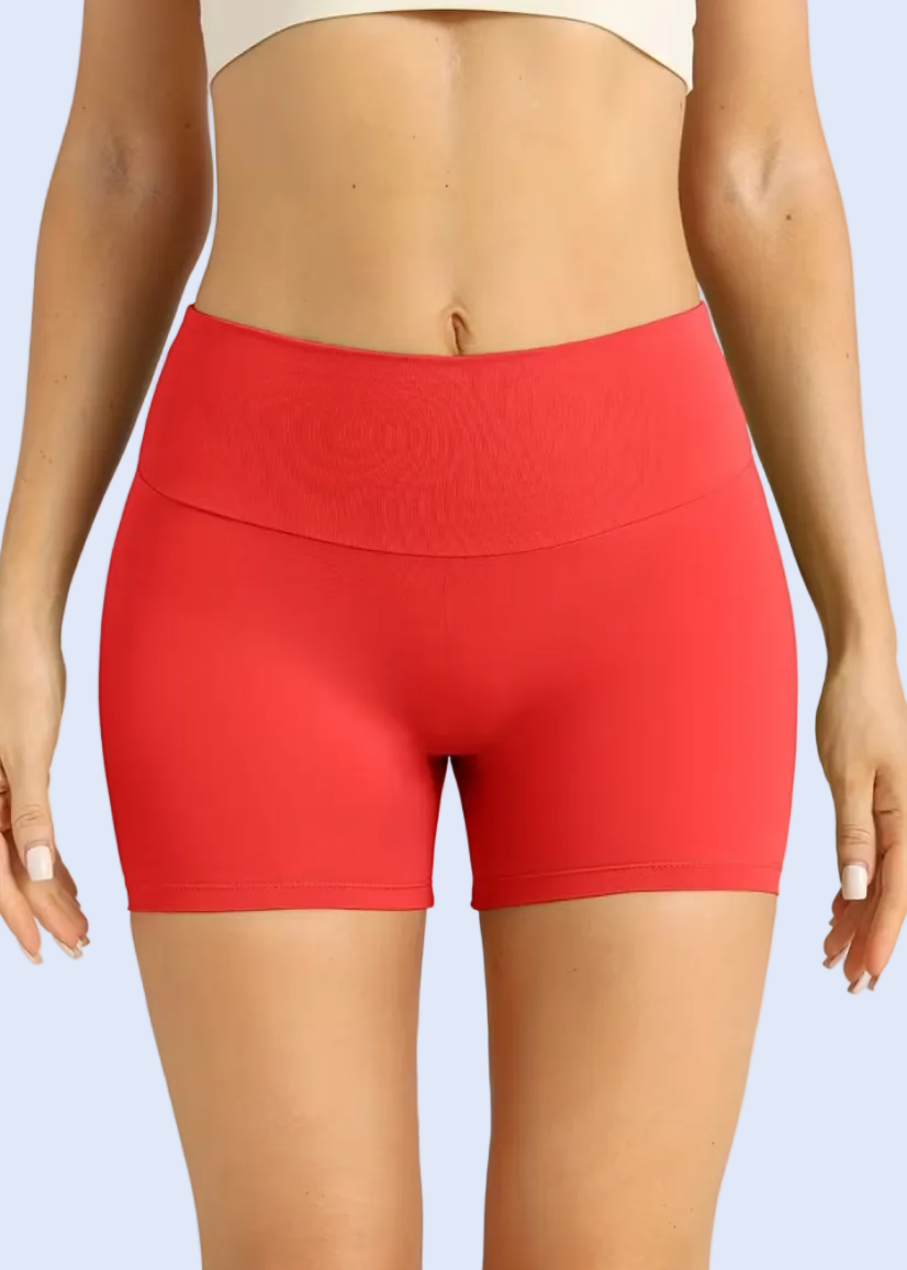 Red shorts worn by a person on a plain background
