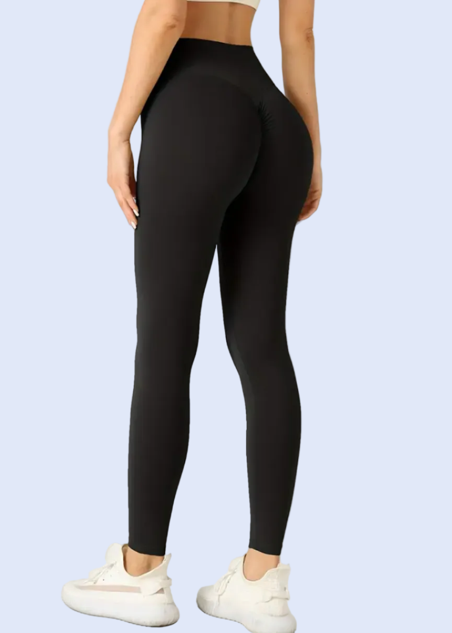 Person wearing black leggings on a white background
