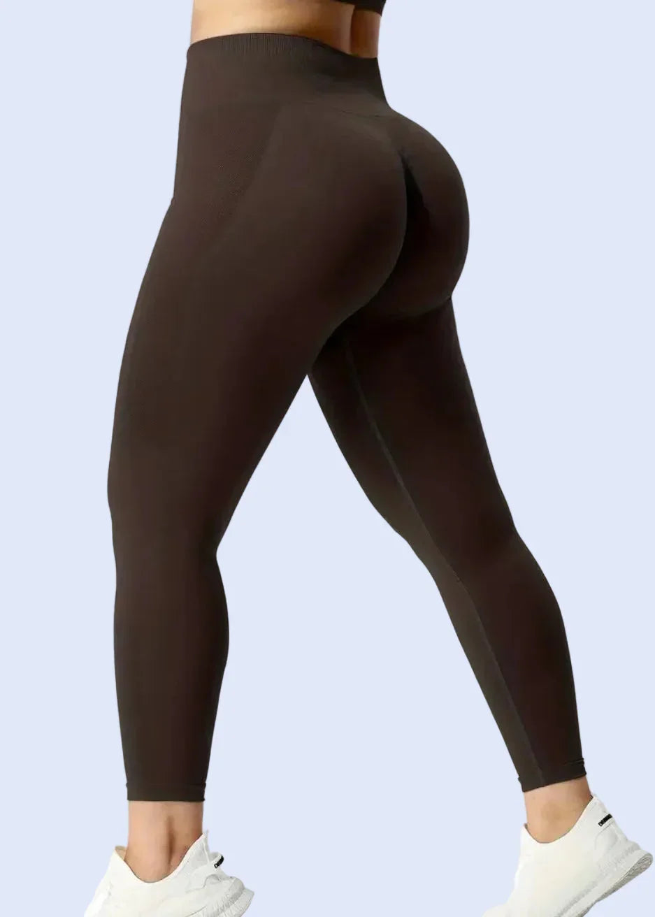 Woman wearing high-waisted brown seamless leggings from GymDeity activewear